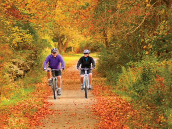 Couple biking at Haley Farm in fall