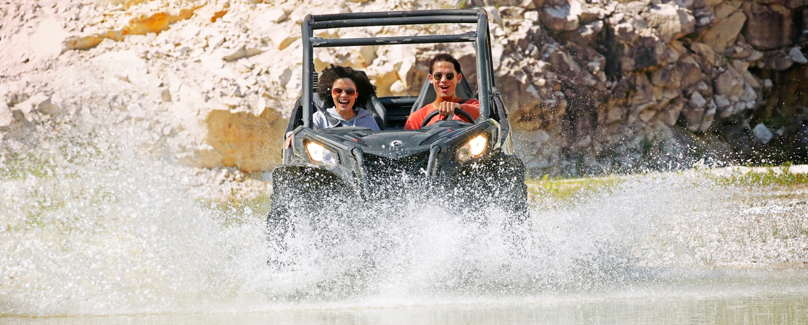 Couple driving through rock quarry