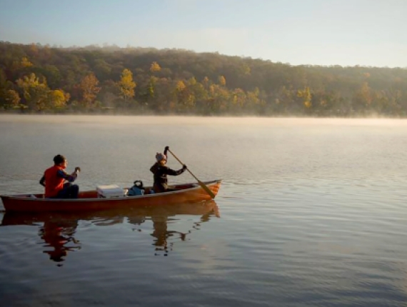Two people canoeing on a misty lake (Instagram@hot_baked_stoke_)