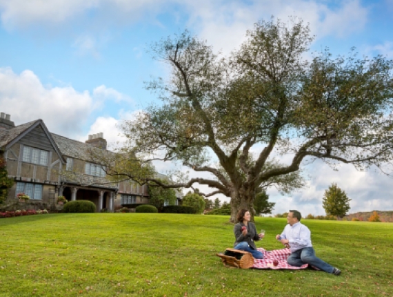 Couple picnicking in front of Topsmead State Park, Litchfield